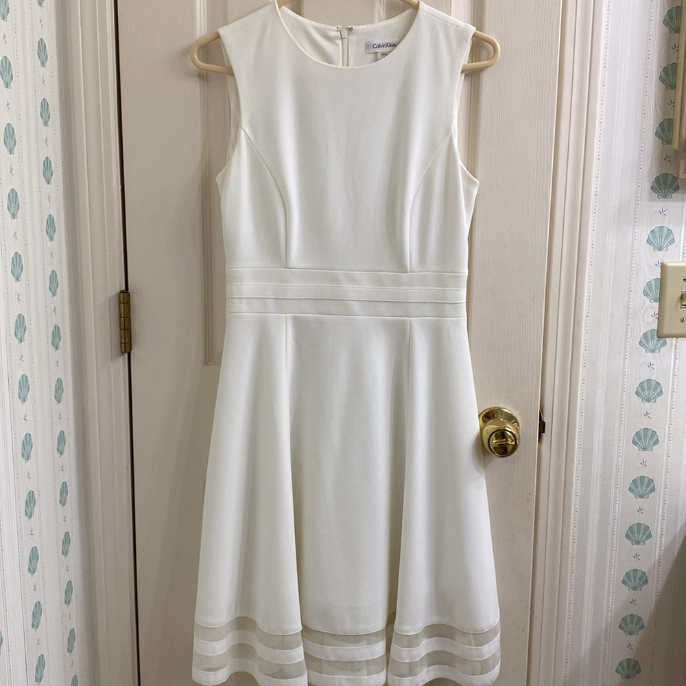 Calvin Klein Fit and Flair dress. Size 6. Cute Peek-a-boo hemline. Ivory color